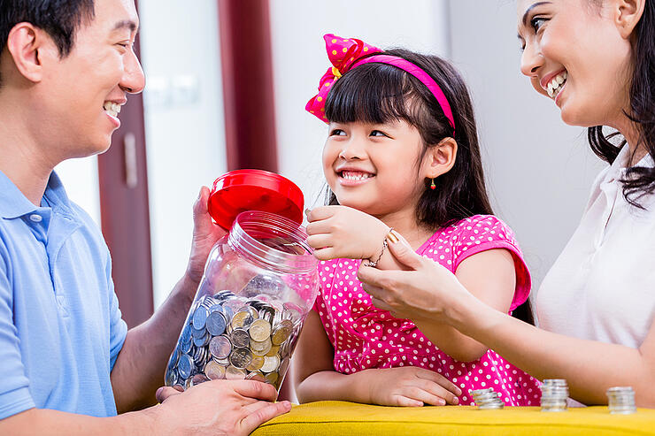 Chinese family saving money for college fund of child, putting c