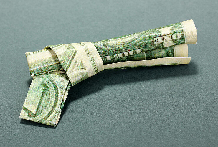 Dollar folded into shirt on blue background