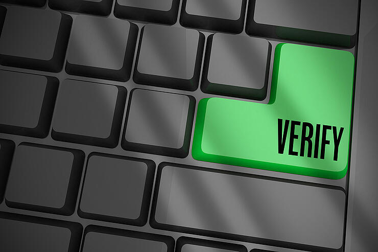 The word verify on black keyboard with green key