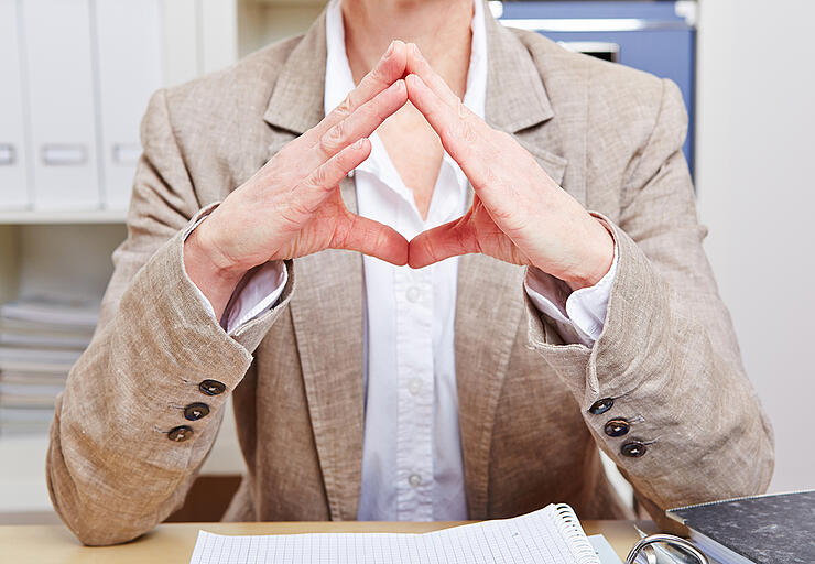 Body language of a senior business woman in her office