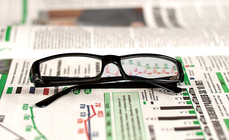 Eyeglasses Lying Around Newspapers