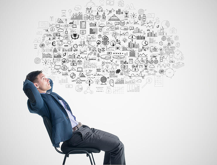 Young businessman sitting thinking dreaming about success profit